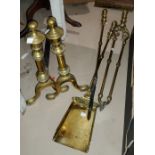 A pair of 19th century brass and steel fire dogs; a set of 3 19th century brass fire irons