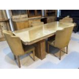 An Art Deco walnut dining suite comprising table with pedestal supports, 200 cm, bow front