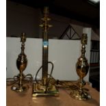 A brass Corinthian column table lamp and two other table lamps