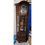 A reproduction long case clock with brass dial, chiming 3 wieght movement and glazed display trunk