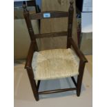 A child's 19th century style armchair with rush seat; an Edwardian rocking chair with spindle back