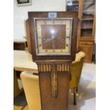 An art deco oak cased granddaughter clock