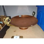 A Continental Art Deco decorative crucible, copper with brass handles and wood mount, 50 cm