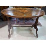 A Victorian oval centre table in inlaid quarter veneered burr walnut, on turned columns and carved