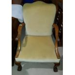 A George I style walnut armchair on ball and claw feet in cream dralon