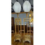 A pair of Chinese carved, pierced, hardwood temple lamp stands, with dragon mounts (converted to