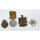 A WWII Defense medal, a War Munition Volunteer badge and 2 other items