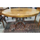 A Victorian inlaid oval centre table with four columns supports Length 120cm