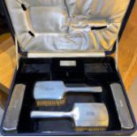 A cased dressing table set of engine turned hallmarked silver London 1936 (no mirror)