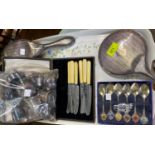 A silver back mirror and brush; souvenir spoons; a cased set of tea knives; silver plate