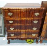 A reproduction continental style stained wood four height chest of drawers with brass fittings, on