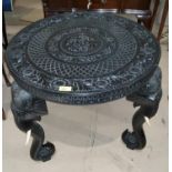 An early/mid 20th century Eastern occasional table, extensively carved and with elephant mask legs
