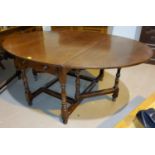 A Titchmarsh and Goodwin traditional style drop leaf oval dining table, block and balluster to