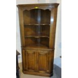 A Royal Oak oak full height corner cupboard with open shelves above and double cupboard below,