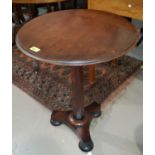 A mahogany circular occasional table with octagonal column with three bun feet, height 67cm