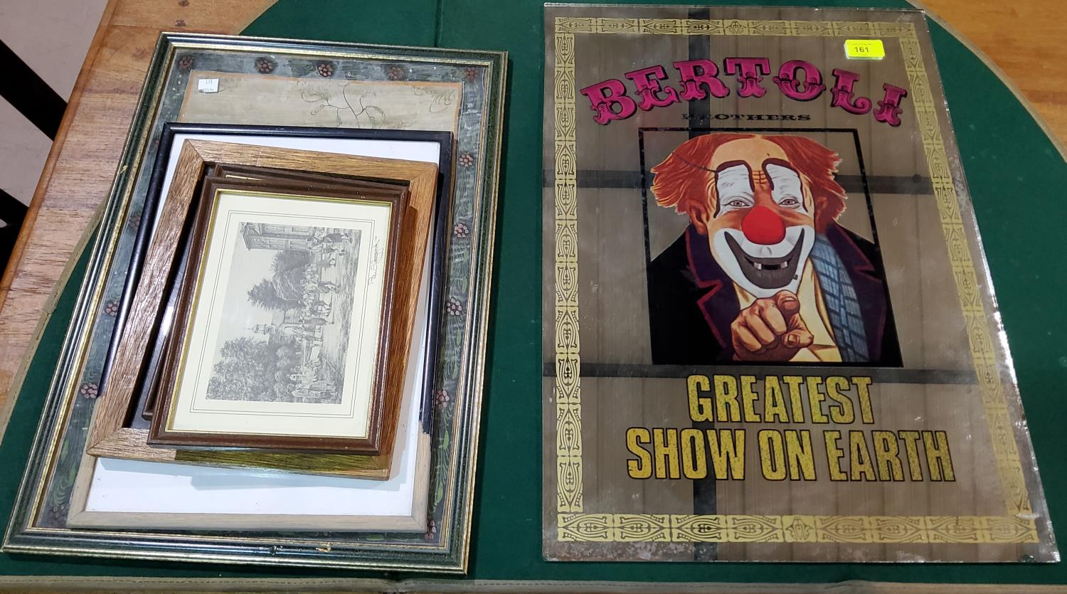 An advertising mirror depicting a clown + other pictures and prints.