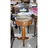 A 1930's oak 3 height cake stand; a light oak pedestal stand with glass dome to the top (dome