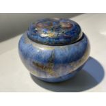 A Wedgwood lustre covered circular pot decorated with dragons against a mottled blue ground,