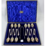A cased set of 12 monogrammed hallmarked silver teaspoons and tongs with accanthus terminals, st.