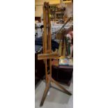A stained pine artist's easel, standing approx: height 177cm.