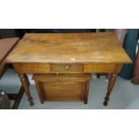 A Victorian style stripped pine desk with single drawer on turned legs