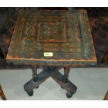 An early 20th century lacquered occasional table; a Victorian footstool