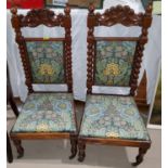 A Victorian pair of walnut chairs, 'prie dieu' style with carved crests, barley twist side