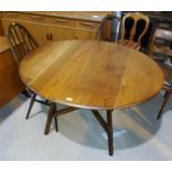 An Ercol drop leaf table & 6 high hoop chairs (4 + 2)