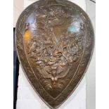 A late 19th/early 20th century unusual bronzed shield decorated in relief with classical scene: Zeus