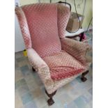 A late 19th/ early 20th century armchair, on carved ball and claw feet, upholstered in pink fabric
