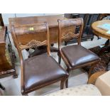 A Regency Harlequin set of 4 Regency dining chairs with wide top rails and drop-in seats, on sabre