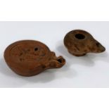 Two Roman terracotta oil lamps, 1 decorated with cherubs, largest length 9.5cm
