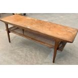 A 1960s teak low table with caned lower tier. 53½' long. Probably Danish