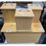 A pine breadbin and three matching storage cannisters