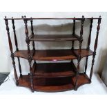 A Regency mahogany serpentine wall rack of five shelves with turned baluster ring turned uprights.