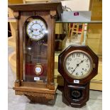 An oak Vienna style wall clock, 29' high; together with an American drop dial clock by the Ansonia