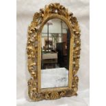 A 19th century Florentine carved giltwood looking glass. 36' high