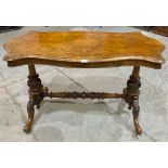 A Victorian walnut centre table, the shaped moulded top raised on acanthus carved and standard