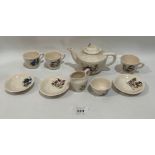 A doll's nine piece tea set, decorated with Noddy scenes. Teapot damaged