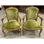 A pair of French stained beechwood and upholstered fauteuil armchairs