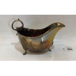 A George V silver sauce boat of helmet form. 6¼' long over handle. Birmingham 1920. Engraved. 5ozs