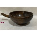 A 19th century primitive treen bowl. 9¾' diam. Stapled repair