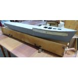 A scratch - built metal boat hull with carrying case. 70' long