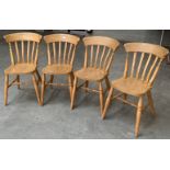 A set of four lath back beechwood kitchen chairs