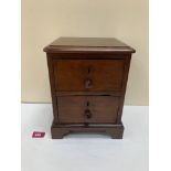 A mahogany miniature chest of two drawers. 11' high