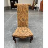 A Victorian rosewood prie-dieu on French cabriole legs