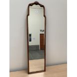 A wall mirror with shaped bevelled plate. 50' high