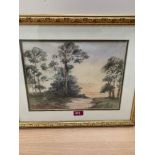 C. LOWNDES. BRITISH 20TH CENTURY Two gilt framed landscape watercolours and a beach scene. The