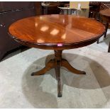 A modern extending dining table with concealed extra leaf on quadripartite reeded support. 43'