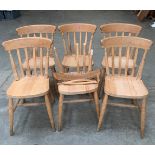 A set of six lath-back beechwood kitchen chairs. (Joints weak generally, one chair broken)